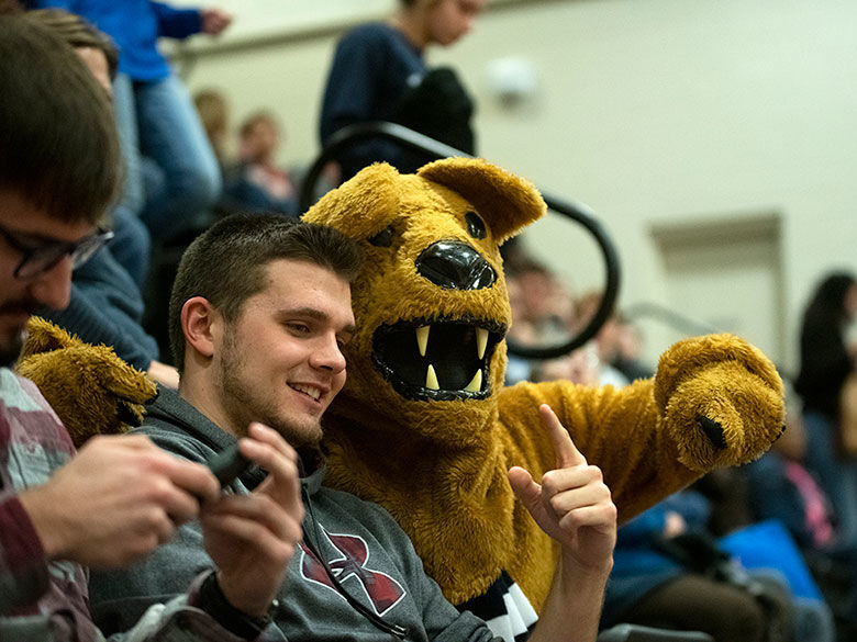 Lion with student and a basketball game.